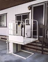 Mac's PL-50 wheelchair elevator lift carrying a rider with a 750 lb capacity platform - ELECTROPEDIC