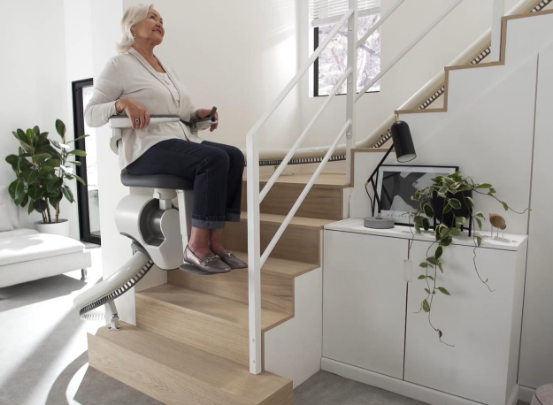 AccessBDD Flow X curved stair lift with ergonomic armrests and Light Assist illumination - ELECTROPEDIC